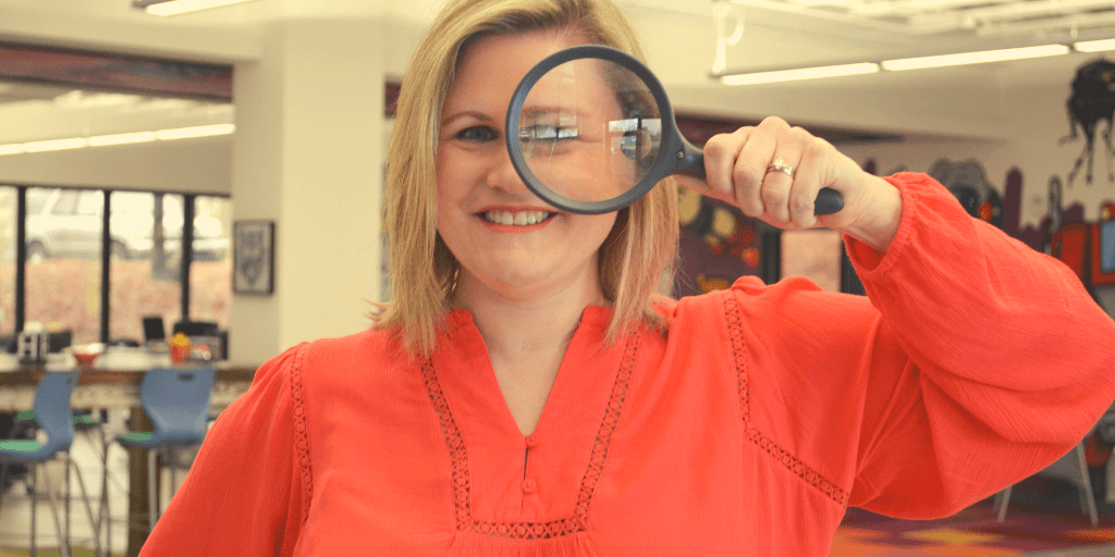 melissa carpenter business development manager of funnel amplified holds a magnifying glass to her left eye