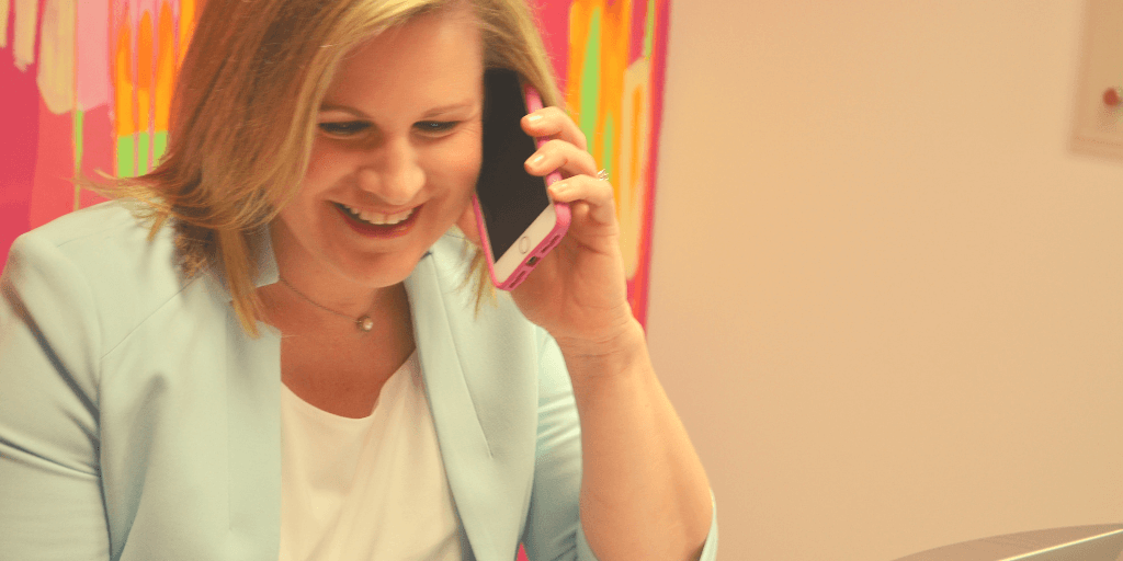 melissa carpenter business development manager of funnel amplified laughs on the phone with a customer