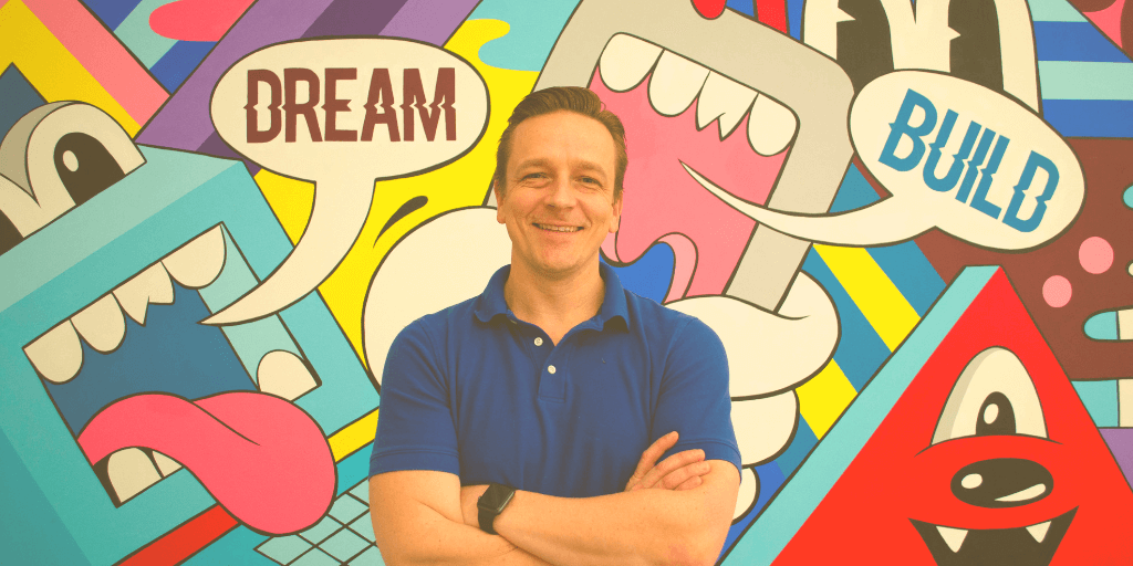daniel willems director of technology funnel amplified in front of a tech mural