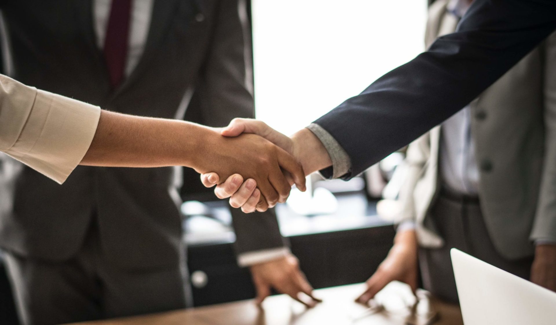 professionals shake hands after meeting through digital selling